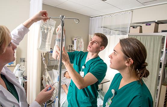 OHIO Nursing students in a real-world setting learning about IV bags.